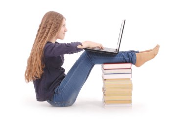 Yana doğru laptop ile belgili tanımlık kitap üstünde oturan öğrenci genç kız