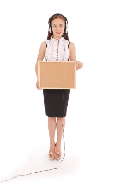 Teenage girl in headphones, holding cork board. — Stock Photo, Image