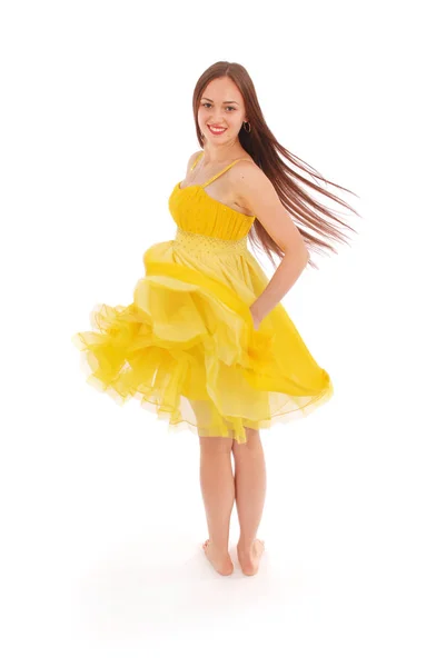 Teenage girl is standing back yellow dress. — Stock Photo, Image