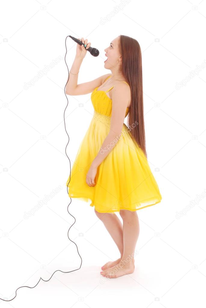 Happy young beautiful girl singing with microphone 