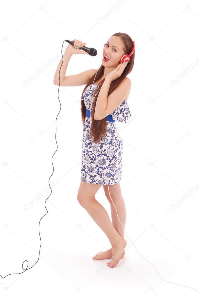 Happy young beautiful girl singing with microphone 