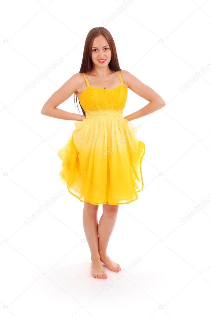 Full body portrait of young woman in yellow dress. 