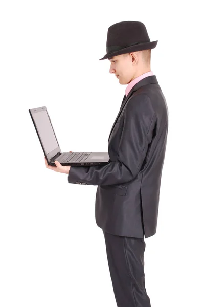 Man in a black suit with a laptop — Stock Photo, Image