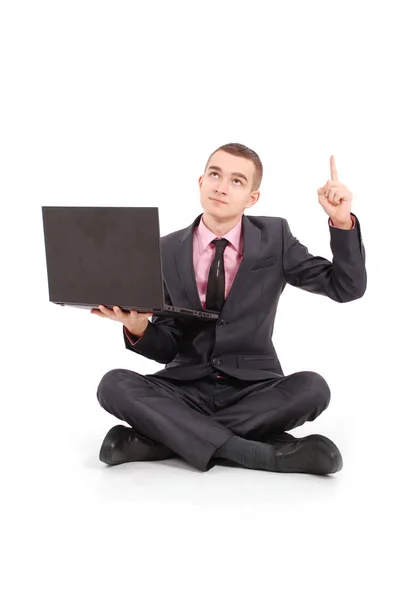 Man in a black suit with a laptop — Stock Photo, Image
