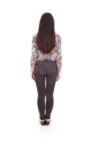 Vista posterior de pie joven hermosa mujer en jeans. chica viendo . —  Fotos de Stock