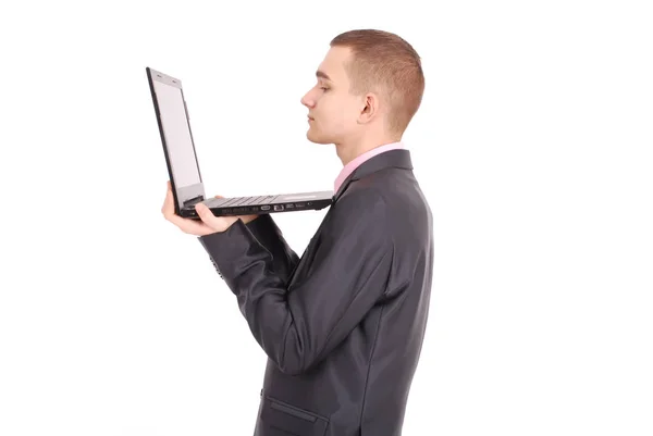 Man in a black suit with a laptop — Stock Photo, Image