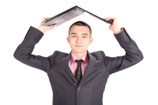 Man in a black suit with a laptop — Stock Photo, Image