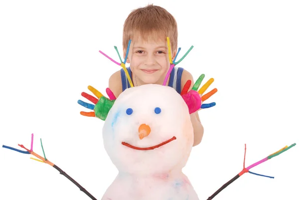 Beautiful boy with hands in paint near color snowman with colored horns and hands — Stock Photo, Image
