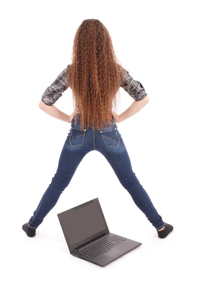 Young girl back standing above a laptop — Stock Photo, Image