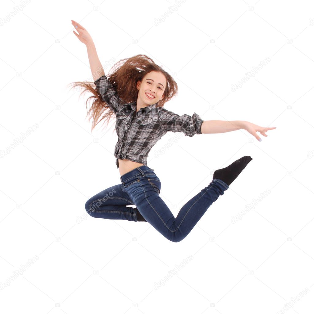 The girl is jumping and smiling.