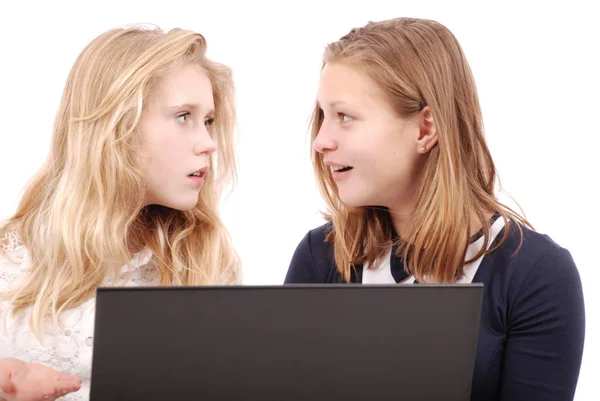 Two shocked girls using laptop — Stock Photo, Image