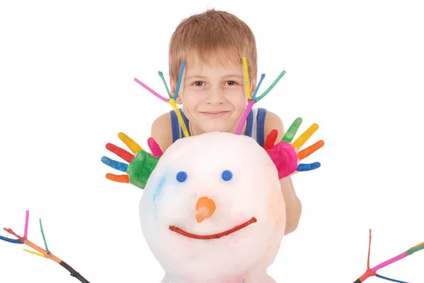 Beautiful boy with hands in paint near color snowman with colored horns and hands — Stock Photo, Image