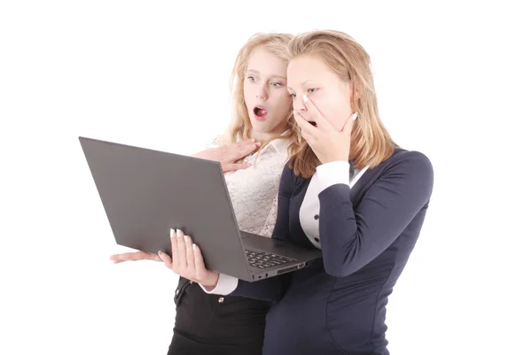 Two shocked girls using laptop Stock Picture