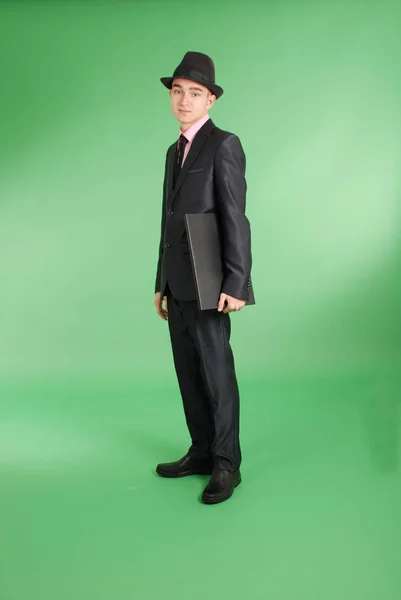 Man in a black suit with a laptop — Stock Photo, Image