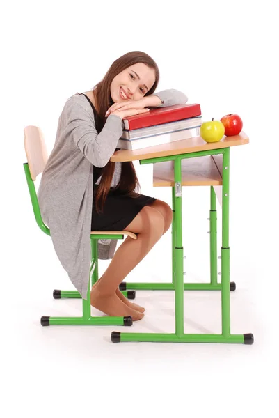 Chica de la escuela sentada en un escritorio —  Fotos de Stock