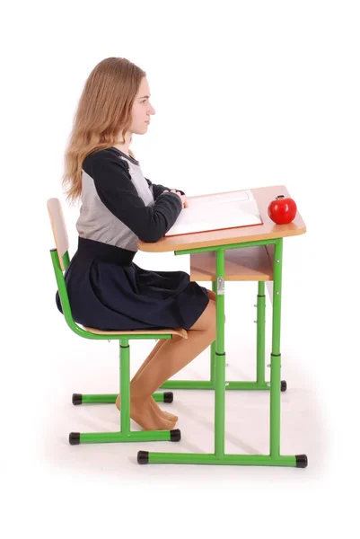 Escola menina sentada em uma mesa — Fotografia de Stock