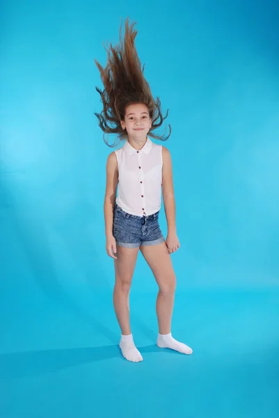 Young girl throws up her hair