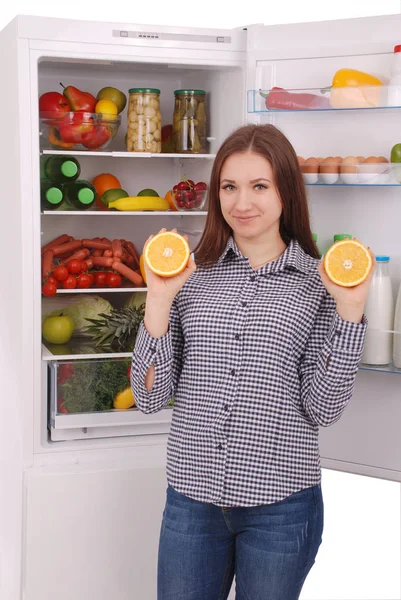Beautiful young girl near the Fridge with healthy food. — Stock Photo, Image