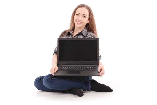 Chica joven sentada y usando un ordenador portátil —  Fotos de Stock