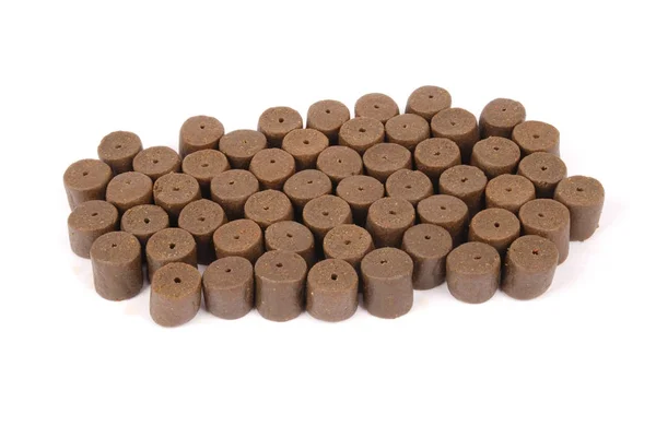 Brown pre-drilled halibut pellets — Stock Photo, Image