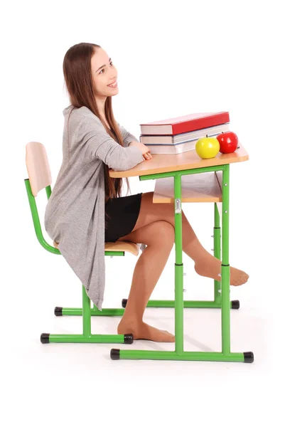 Escola menina sentada em uma mesa — Fotografia de Stock