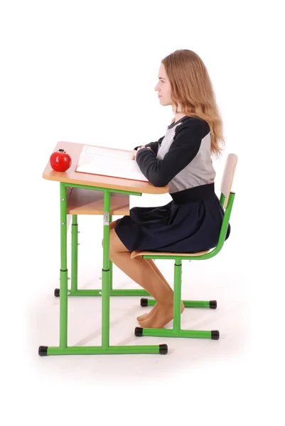 Escola menina sentada em uma mesa — Fotografia de Stock