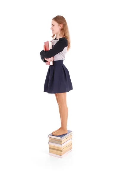 Az emberek, tinédzser és iskolai koncepció - tinédzser iskola lány állt a verem a könyvek — Stock Fotó
