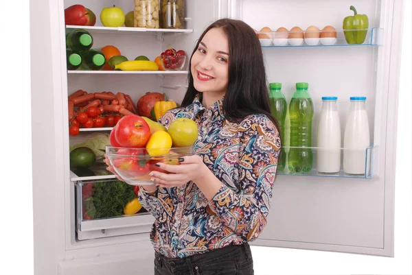 Menina bonita perto da geladeira com comida saudável . — Fotografia de Stock