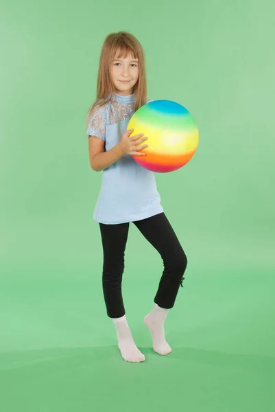 Girl holding colored ball in hand — Stock Photo, Image