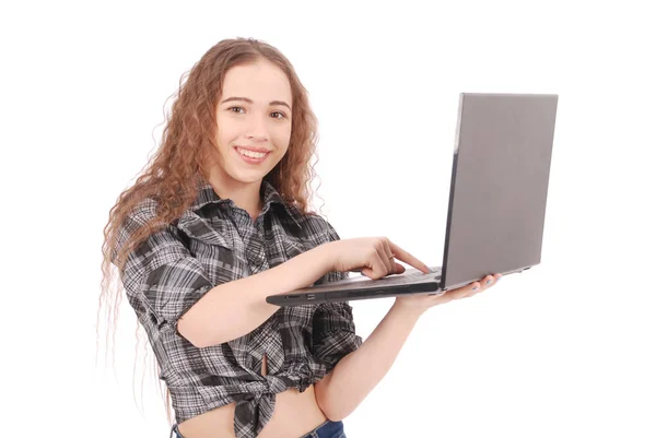 Young girl standing and using a laptop — Stock Photo, Image