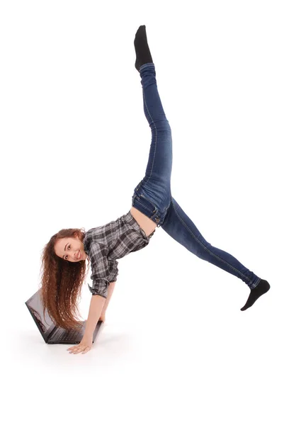Girl doing acrobatic stunt and using laptop — Stock Photo, Image