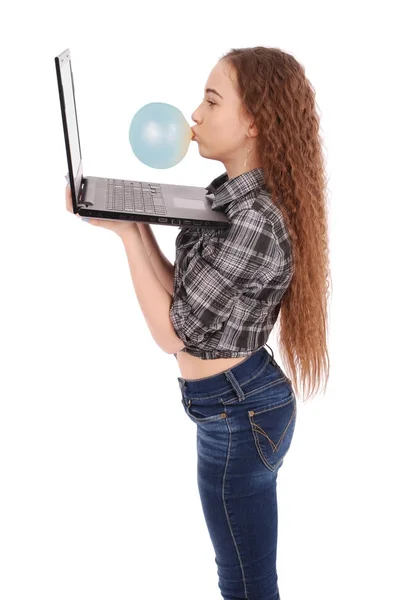 Young girl Inflating chewing gum and using laptop — Stock Photo, Image