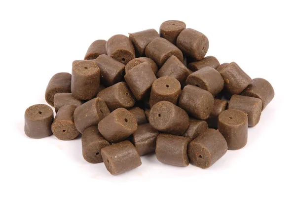 Brown pre-drilled halibut pellets — Stock Photo, Image