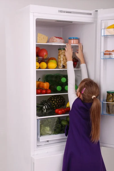 Beautiful  girl near the Fridge with healthy food. — Stock Photo, Image