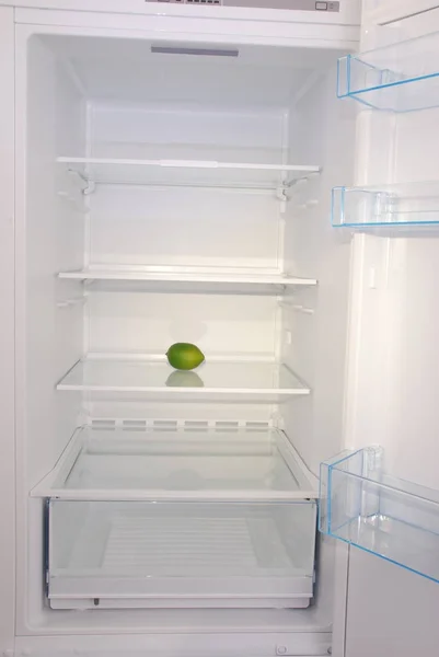 One lemon in open empty refrigerator. — Stock Photo, Image