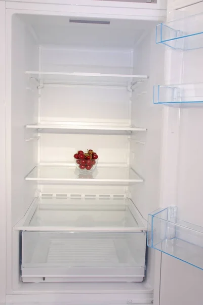 Cherries in open empty refrigerator. — Stock Photo, Image