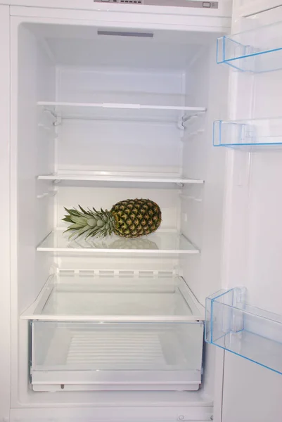 Pineapple inside in empty clean refrigerator — Stock Photo, Image