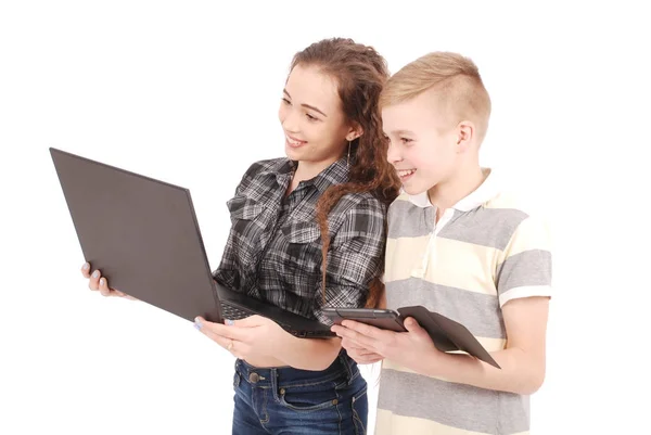 Two kids playing and surfing the web on digital tablet and laptop. — Stock Photo, Image