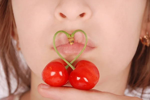 Partie inférieure du visage de la fille avec deux cerises rouges fruits avec tige en forme de coeur — Photo