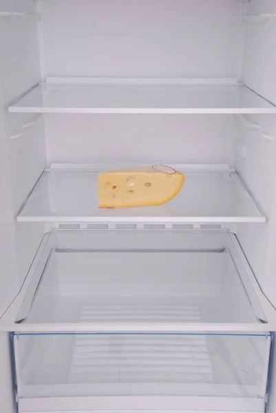 One cheese in open empty refrigerator. — Stock Photo, Image