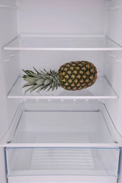 Pineapple inside in empty clean refrigerator