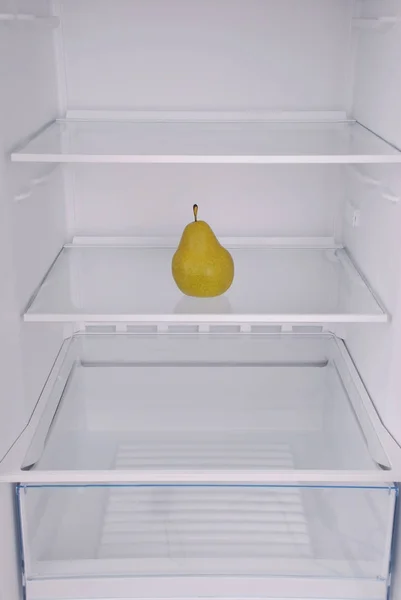 One pear in open empty refrigerator. — Stock Photo, Image