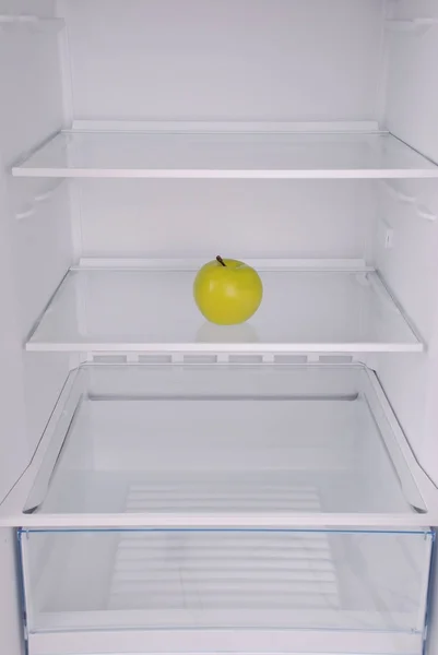 One apple in open empty refrigerator. — Stock Photo, Image