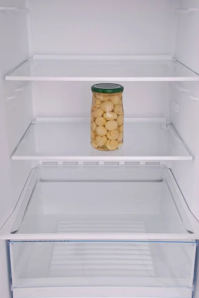 Pickled mushrooms inside in empty clean refrigerator — Stock Photo, Image