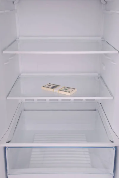 Dollars inside in empty clean refrigerator