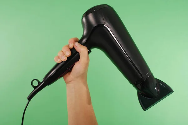 Hand holding hair dryer — Stock Photo, Image