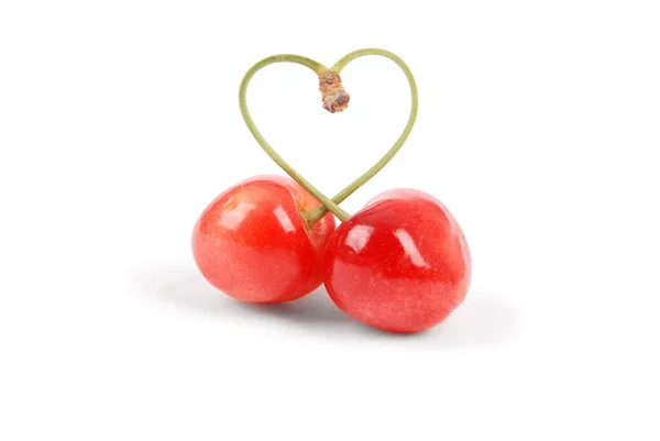 Par søde kirsebærfrugter med hjerteformet stilk - Stock-foto