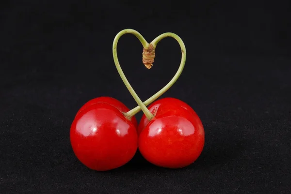 Par de frutas de cereja doce com caule em forma de coração — Fotografia de Stock