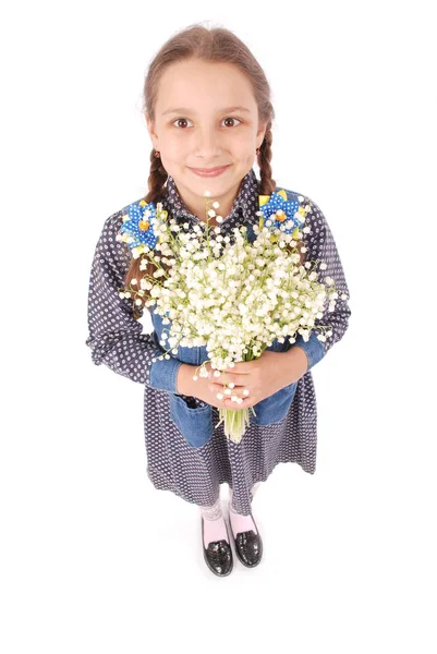 Portrait of a happy pretty girl holds a flower of a lily of the valley. — Stock Photo, Image