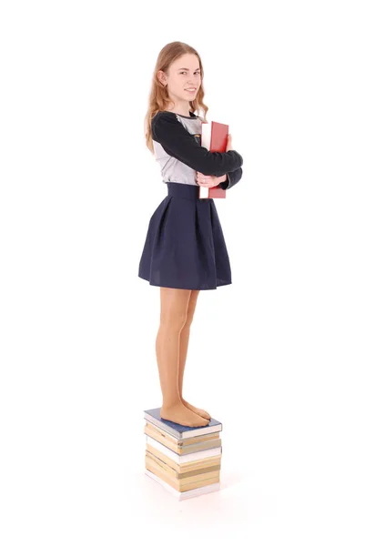 Education, people, teenager and school concept - teenager school girl standing on stack of books — Stock Photo, Image